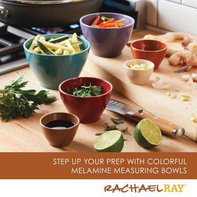 Colorful bowls with ingredients, lime halves, and knife on a kitchen counter.