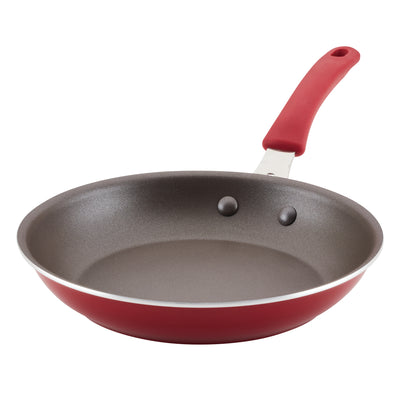 Red frying pan with a non-stick surface and a red handle.