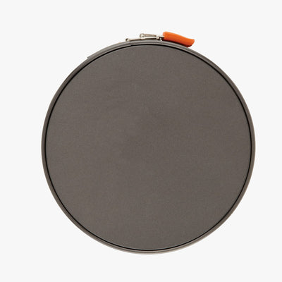 Round gray container with lid, secured by a small orange latch.