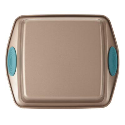 A square baking sheet with teal silicone grips on the handles.