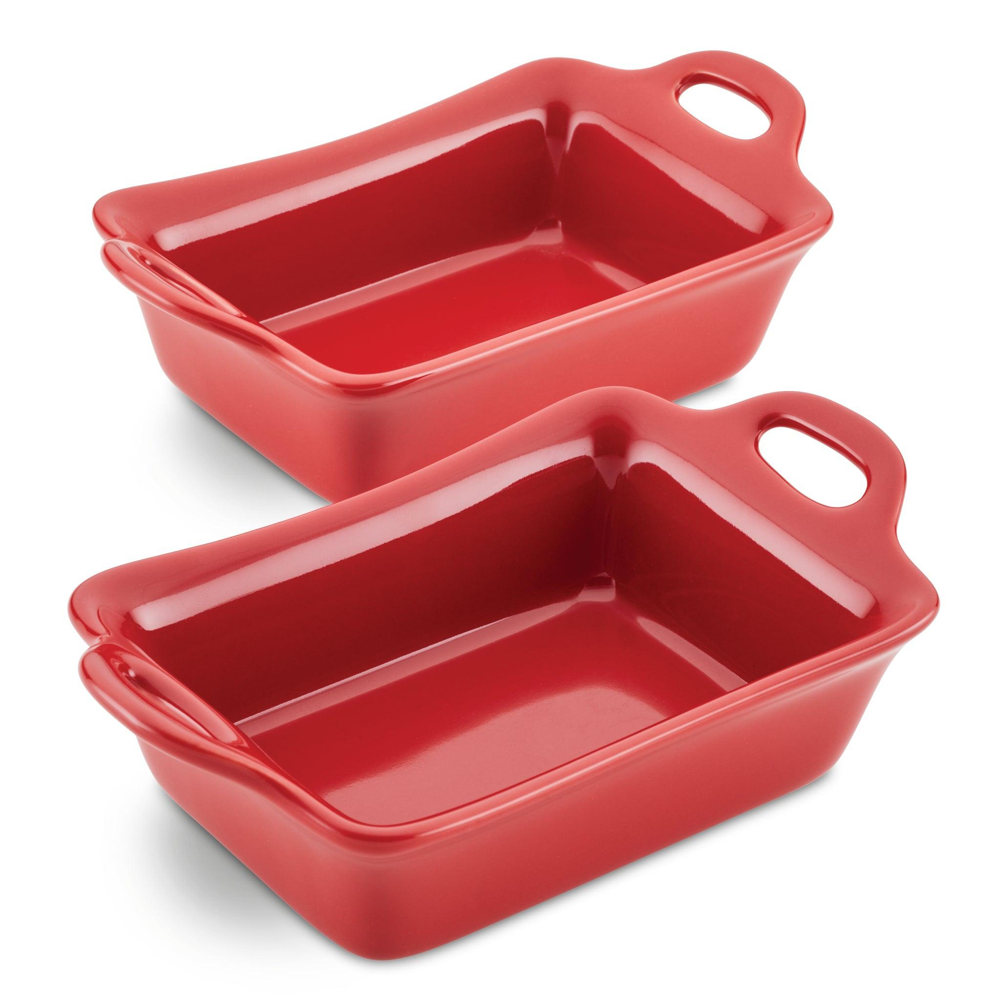 Two red ceramic baking dishes with handles on a white background.