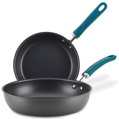 Two black frying pans with blue handles stacked together.