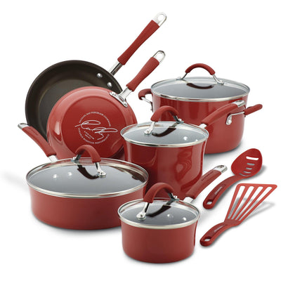 Red cookware set with lids and utensils.