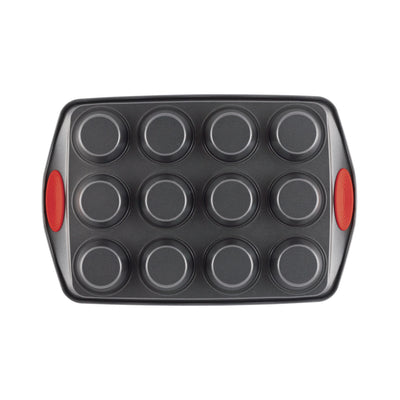 Muffin tin with twelve round molds and red handles on each side.