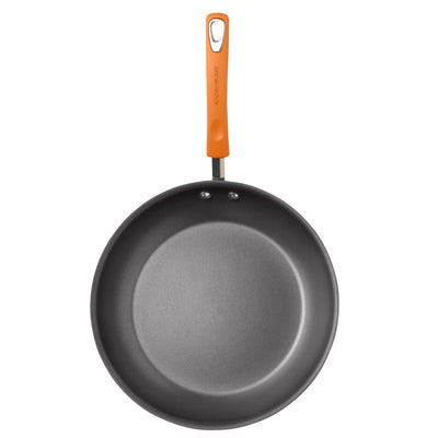 Non-stick frying pan with orange handle, viewed from above.