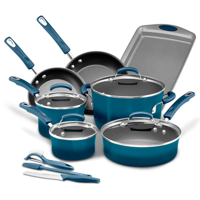 A set of blue cookware and utensils arranged neatly on a white surface.