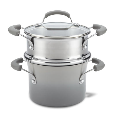 Stainless steel double boiler with glass lid and gray handles.