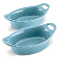 Two blue ceramic baking dishes with handles.
