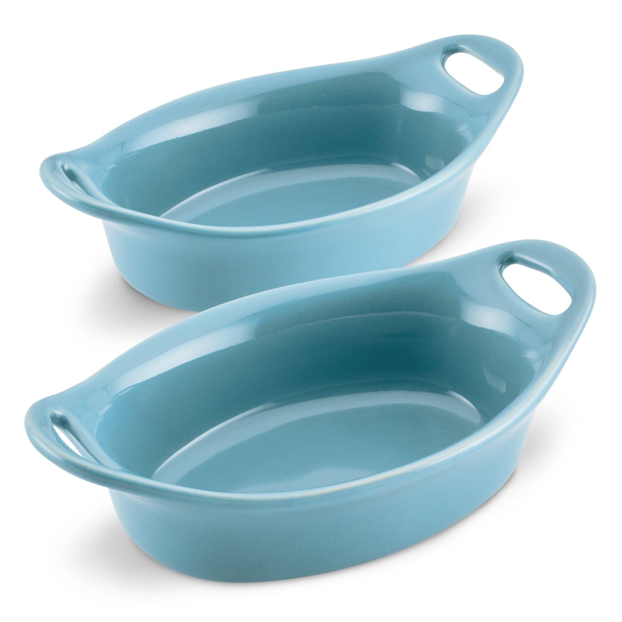 Two blue ceramic baking dishes with handles.