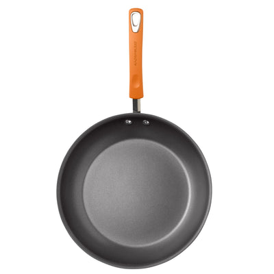 Black frying pan with an orange handle, viewed from above.