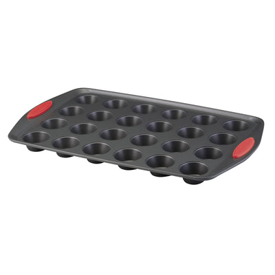 Muffin baking tray with twenty-four cups and red silicone handles.