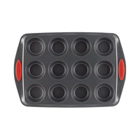 A 12-cup muffin pan with red silicone handles.
