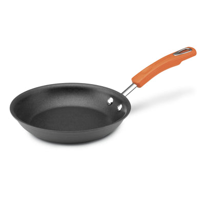 A nonstick frying pan with an orange handle is shown on a white background.