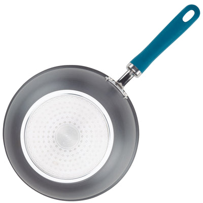 A frying pan with a teal handle, viewed from above.