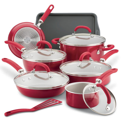 Red cookware set with pots, pans, lids, baking tray, and a spatula.