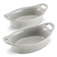 Two empty gray oval ceramic baking dishes with handles.