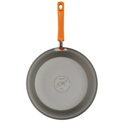 Nonstick frying pan with orange handle, viewed from above.