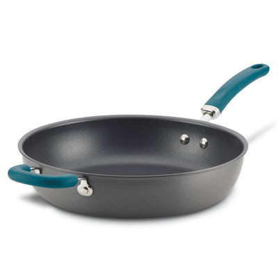 Black frying pan with a teal handle and helper handle on a white background.