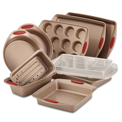 A set of eight non-stick bakeware items with red handles.