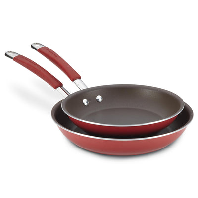 Two red frying pans with non-stick surfaces, stacked on top of each other.