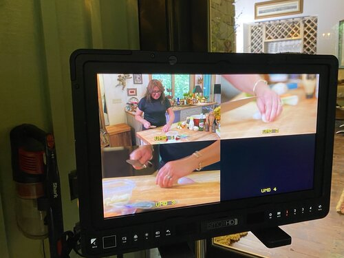 TV screen shows cooking scene with multiple camera angles.