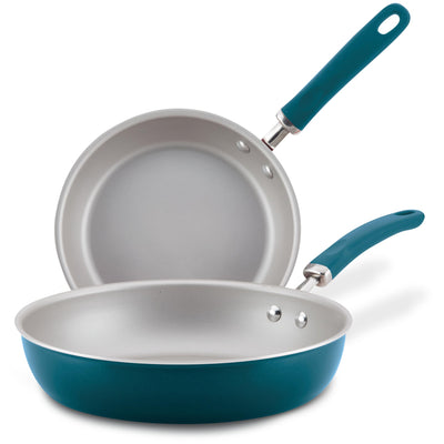 Two teal frying pans with silver interiors and matching handles.