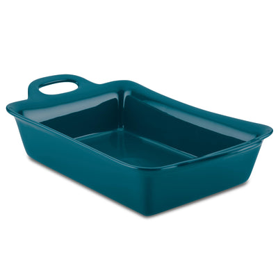 Teal ceramic baking dish with handles on a white background.