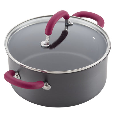 A gray cooking pot with a glass lid and red handles.