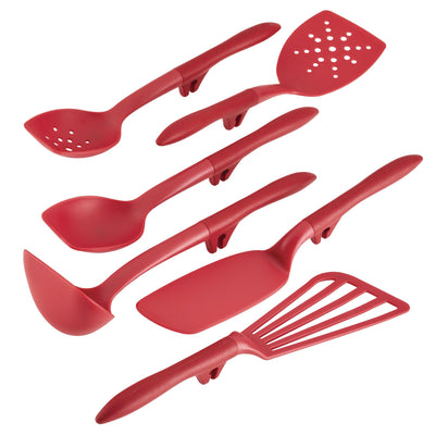 Red kitchen utensils, including spoons and spatulas, arranged on a white surface.