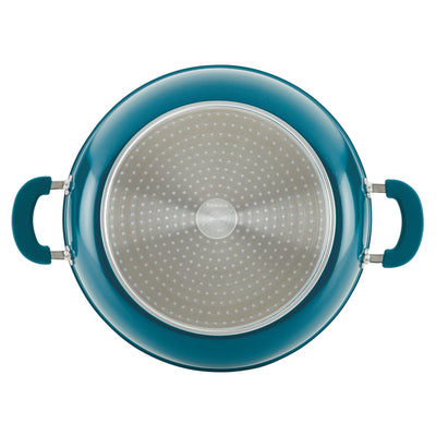 Top view of a blue cooking pot with handles and a perforated lid.