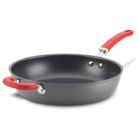 Black frying pan with a red handle and a deep cooking surface.