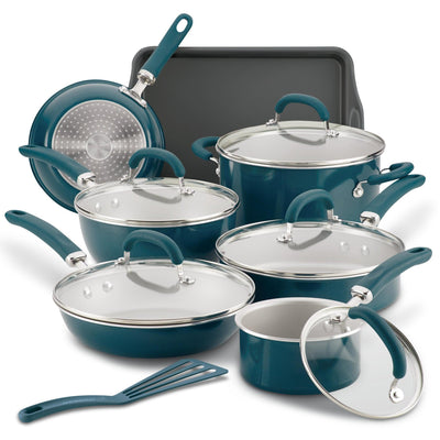 A set of teal nonstick cookware with lids and a spatula.