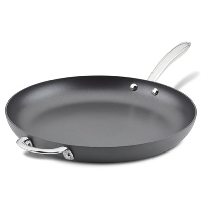 Black frying pan with a silver handle and extra side handle on a white background.