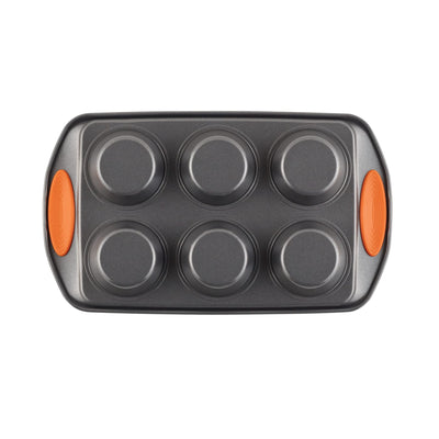 Six-cup muffin tin with orange handles, viewed from above.