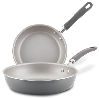 Two gray frying pans with black handles, one stacked behind the other.