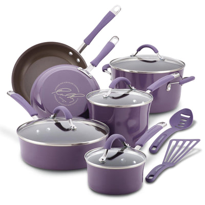 Purple nonstick cookware set with glass lids and matching utensils.