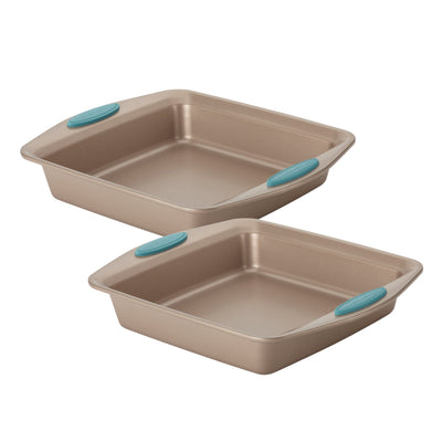 Two square baking pans with teal handles stacked slightly offset.