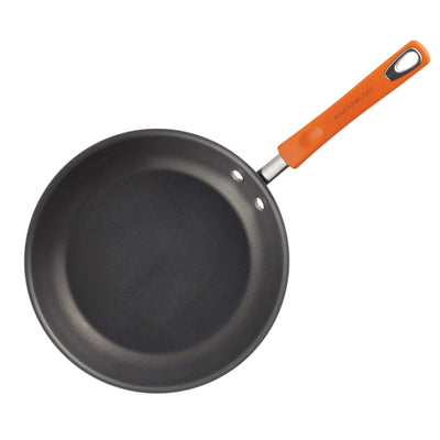 Black frying pan with an orange handle on a white background.