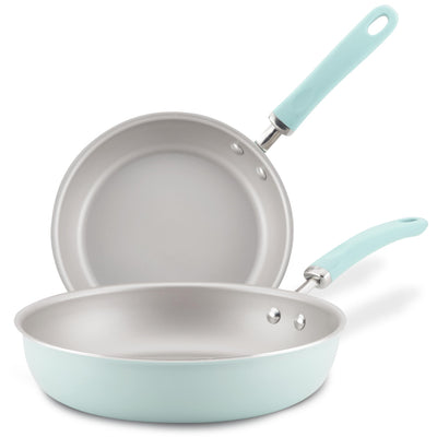 Two light blue frying pans with silver interiors and matching handles.