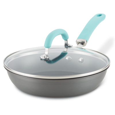 Gray frying pan with a glass lid and a light blue handle.