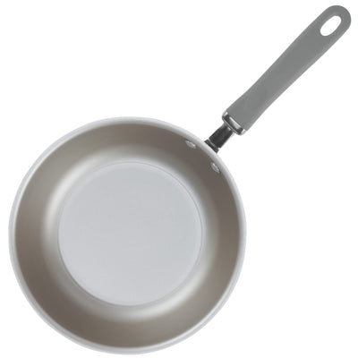 A gray frying pan with a handle seen from above.