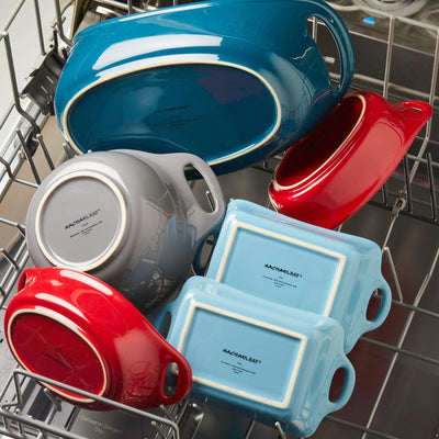 Colorful ceramic dishes arranged in an open dishwasher rack.