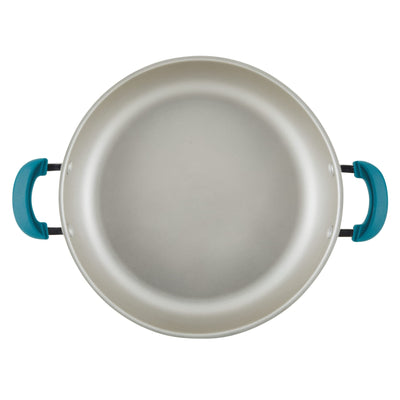 Top view of a round, silver non-stick pan with blue handles.