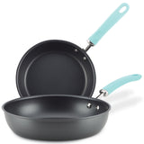 Two black frying pans with teal handles, stacked on top of each other.