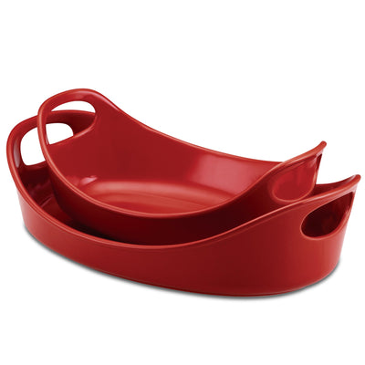 Two nested red ceramic baking dishes with handles.