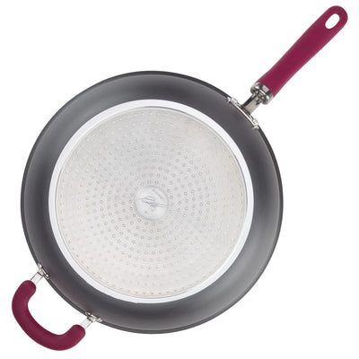 Top view of a non-stick frying pan with red handles.