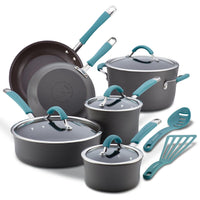 A set of dark gray pots, pans, and utensils with teal handles.