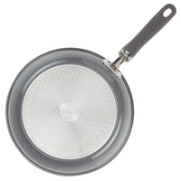 Top view of a gray frying pan with a stainless steel base and black handle.