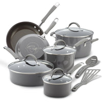 Set of gray cookware with lids and kitchen utensils.