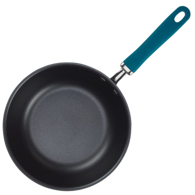 A non-stick frying pan with a teal handle.